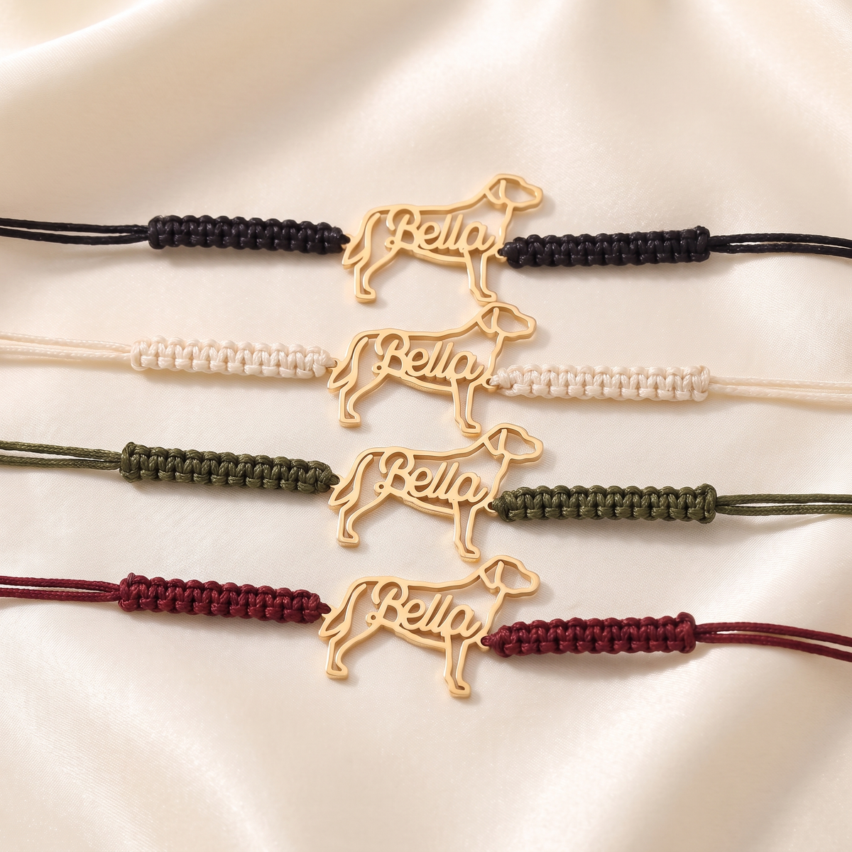 The four cord colors: black, ivory, army green and burgundy, each with a gold pet name charm