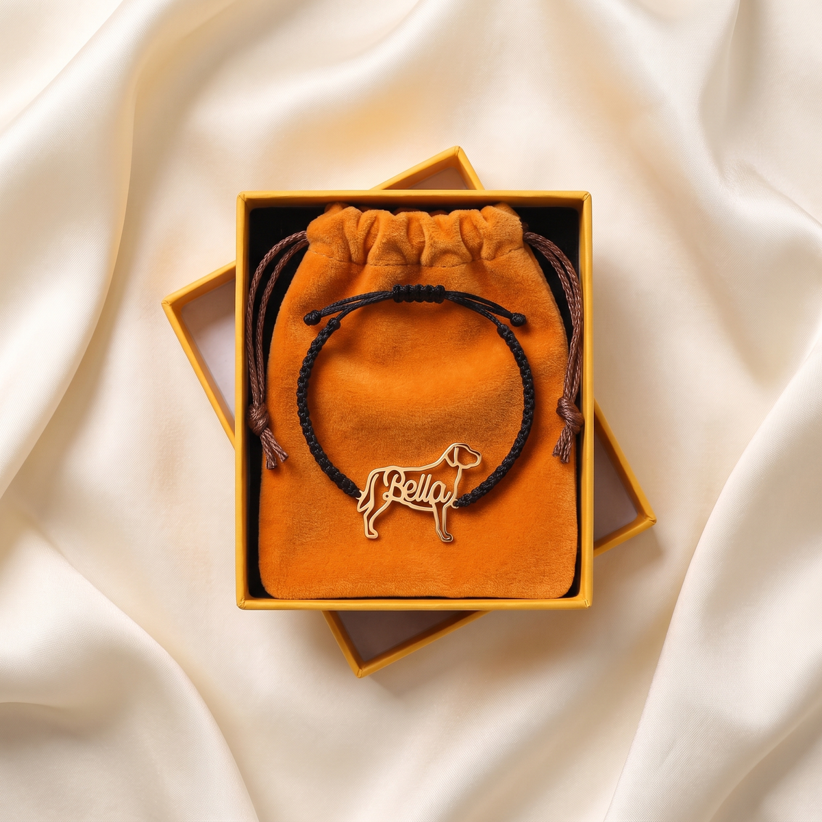 Pawbau packaging: yellow gift box and orange velvet pouch with the bracelet